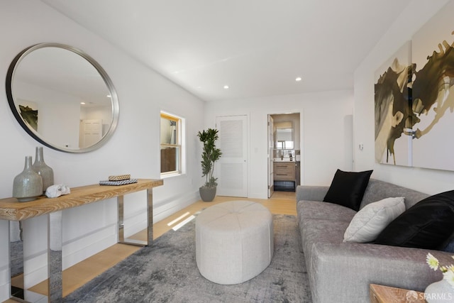 living area featuring light wood-style flooring, recessed lighting, and baseboards