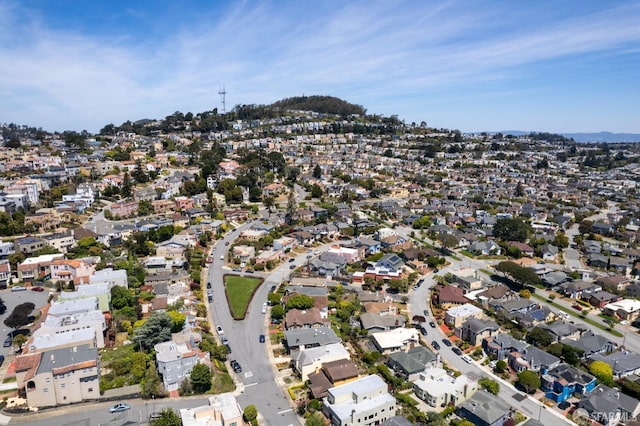 aerial view of property and surrounding area with nearby suburban area