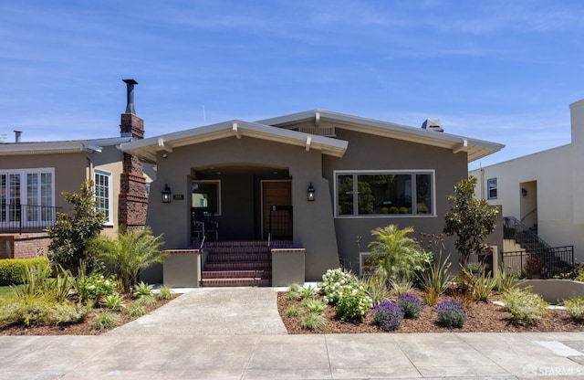 view of front of house featuring stucco siding and covered porch