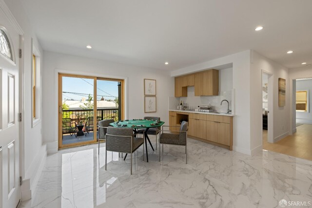 dining area featuring recessed lighting, light marble finish floors, and baseboards