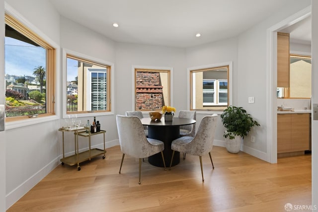 dining space featuring light wood-style floors, recessed lighting, and baseboards