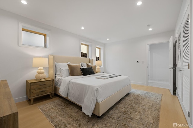 bedroom featuring light wood-type flooring, recessed lighting, and baseboards