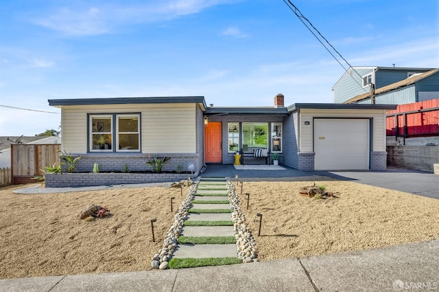 view of front of home with a garage and a porch