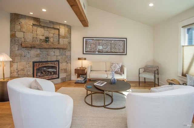 living room featuring wood finished floors, a fireplace, baseboards, lofted ceiling, and recessed lighting