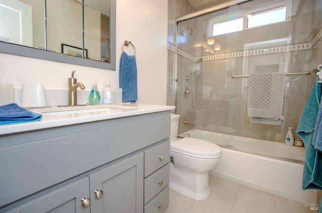 bathroom featuring enclosed tub / shower combo, vanity, toilet, and tile patterned floors
