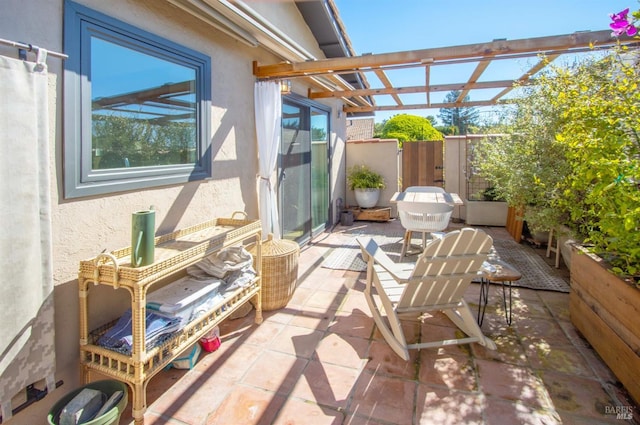 view of patio / terrace featuring a pergola and fence