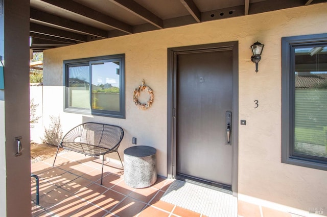 entrance to property with stucco siding