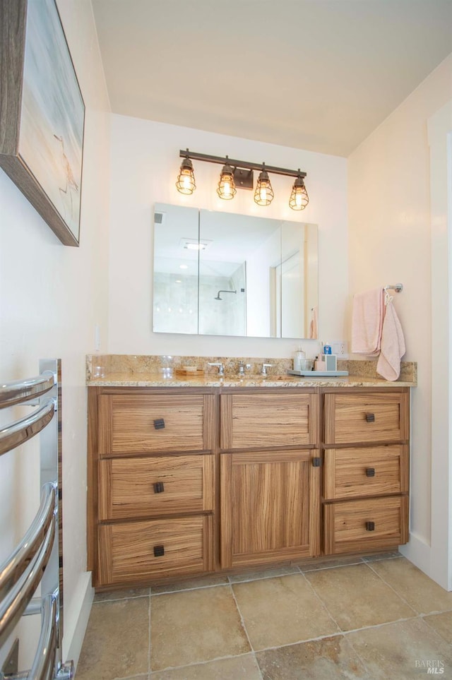 bathroom with vanity and baseboards