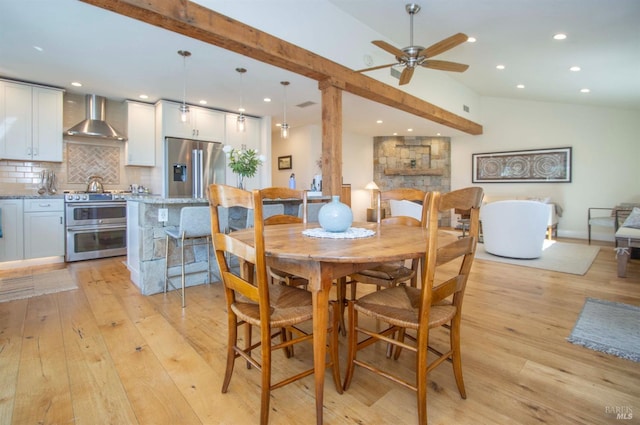 dining room with vaulted ceiling, recessed lighting, a ceiling fan, and light wood-style floors
