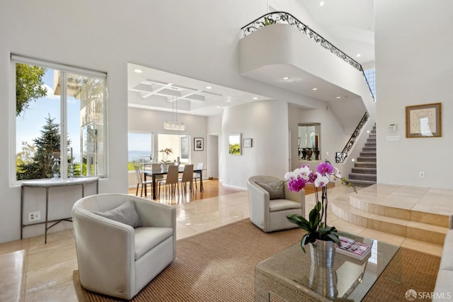 living room featuring recessed lighting, a high ceiling, stairway, and light tile patterned flooring