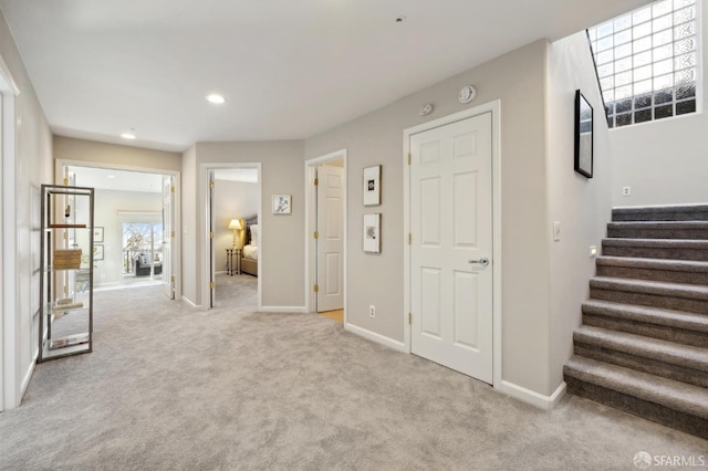 unfurnished bedroom with recessed lighting, light carpet, and baseboards