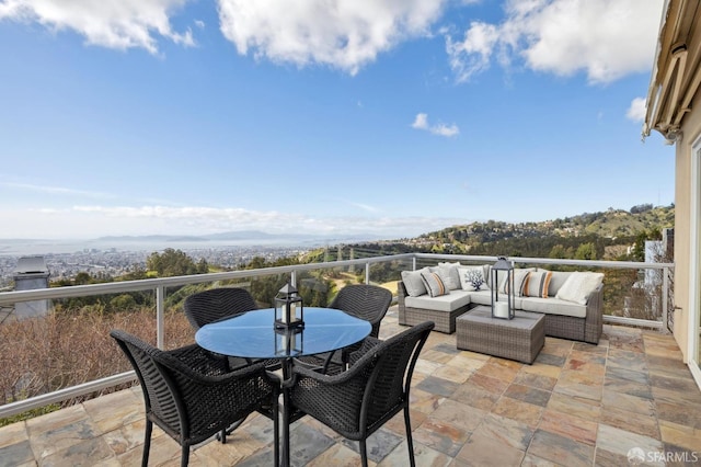 balcony featuring an outdoor hangout area, a patio, and outdoor dining space