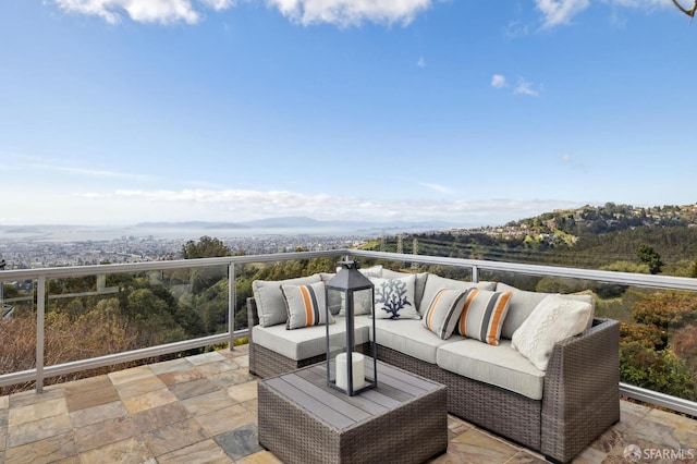 balcony featuring a mountain view and an outdoor hangout area