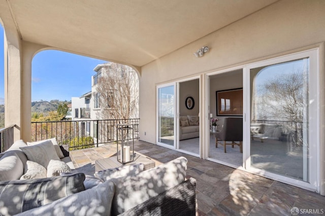 view of patio with an outdoor hangout area and a balcony