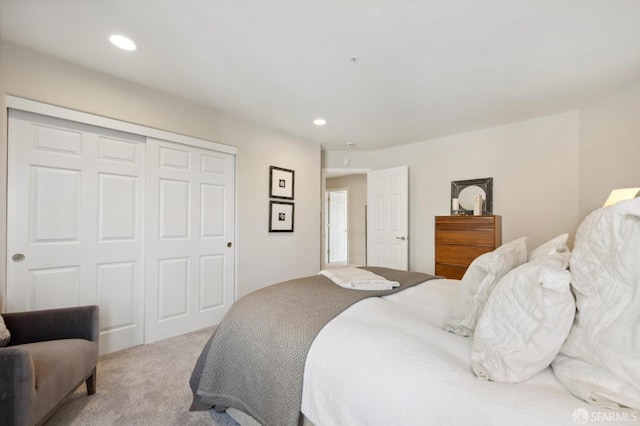 carpeted bedroom with a closet and recessed lighting