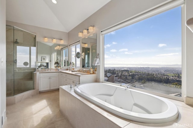 full bath featuring double vanity, lofted ceiling, a garden tub, a shower stall, and a sink