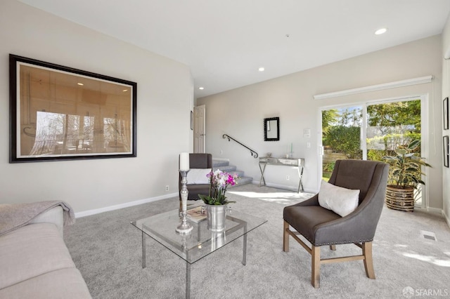 living room featuring stairs, carpet flooring, and baseboards