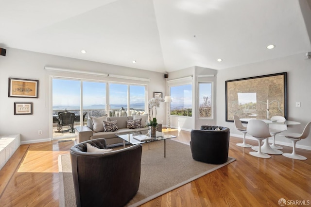 living area featuring recessed lighting, vaulted ceiling, baseboards, and wood finished floors