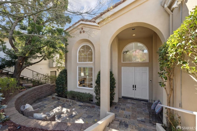 doorway to property with stucco siding