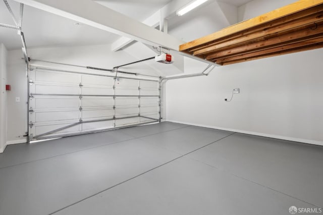 garage with baseboards and a garage door opener