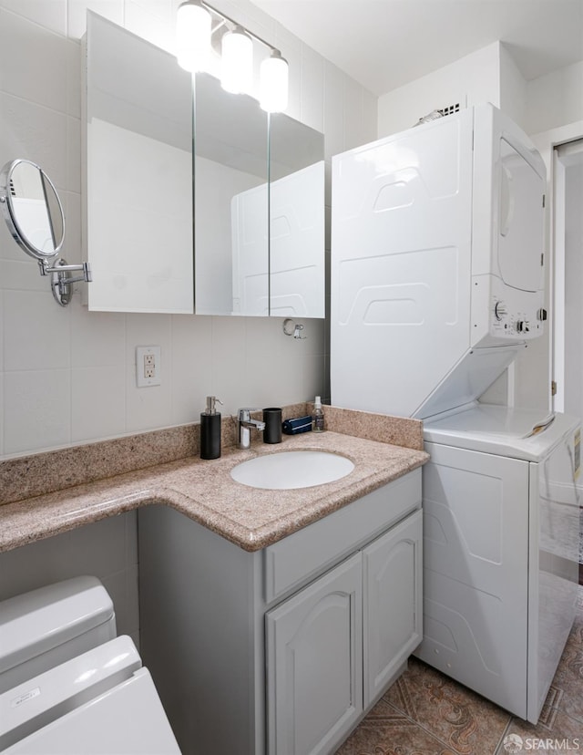 1520 Ofarrell St Unit 4, San Francisco, CA 94115 - bathroom featuring stacked washer / drying machine, vanity, and tile patterned floors