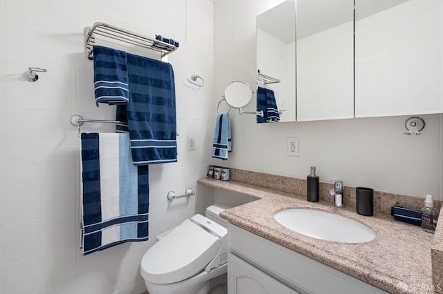 1520 Ofarrell St Unit 4, San Francisco, CA 94115 - bathroom with vanity, tile walls, and a towel warming rack