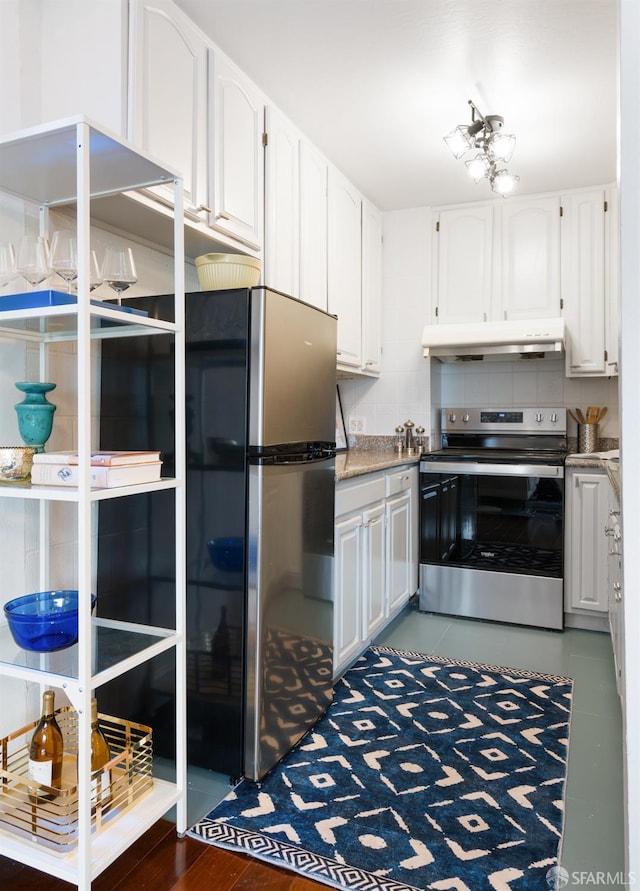 1520 Ofarrell St Unit 4, San Francisco, CA 94115 - kitchen with stainless steel appliances, under cabinet range hood, white cabinetry, and decorative backsplash