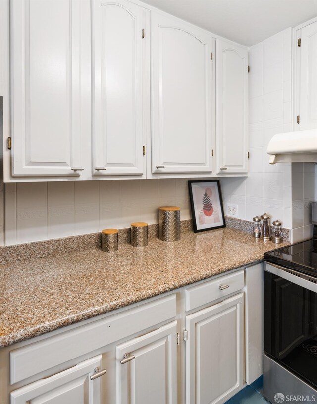 1520 Ofarrell St Unit 4, San Francisco, CA 94115 - kitchen featuring stainless steel range with electric cooktop, ventilation hood, white cabinetry, backsplash, and light stone countertops
