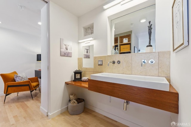 bathroom featuring decorative backsplash and wood-type flooring