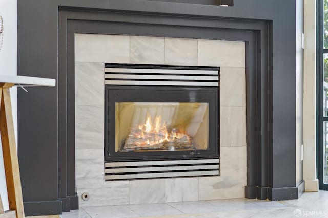 interior details featuring a tiled fireplace