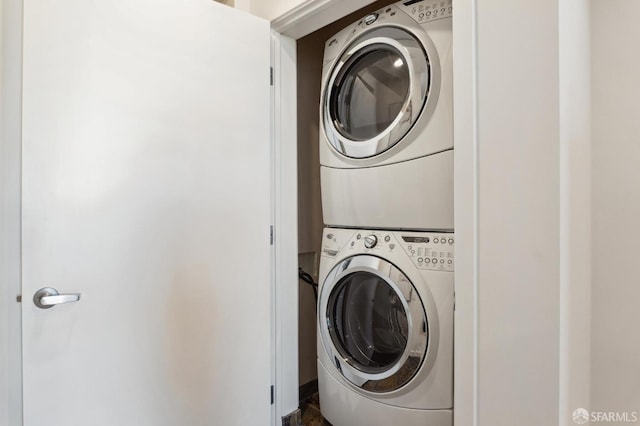 laundry area with stacked washer / dryer