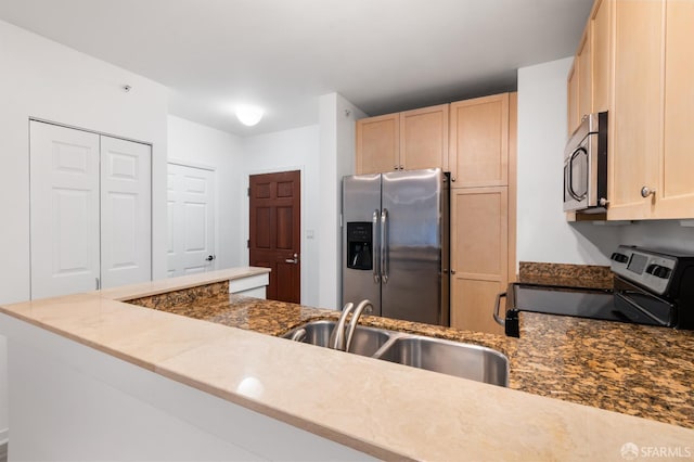 1843 Sutter St Unit 301, San Francisco, CA 94109 - kitchen featuring appliances with stainless steel finishes, a sink, light brown cabinetry, and dark stone countertops