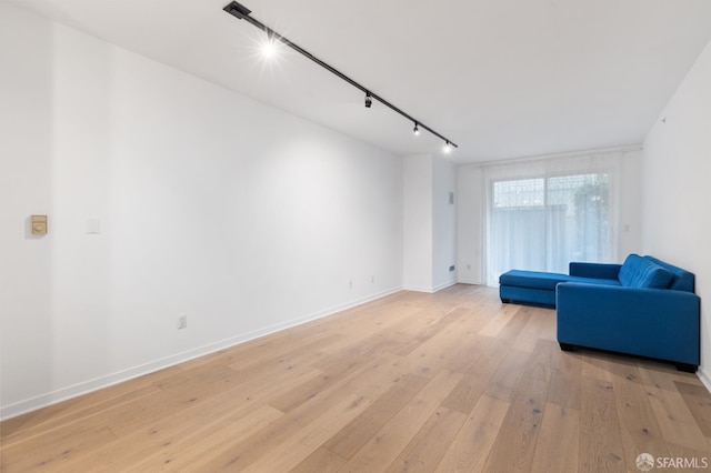 1843 Sutter St Unit 301, San Francisco, CA 94109 - unfurnished living room featuring rail lighting, light wood-style flooring, and baseboards