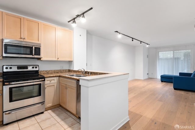 1843 Sutter St Unit 301, San Francisco, CA 94109 - kitchen featuring appliances with stainless steel finishes, rail lighting, a sink, and open floor plan
