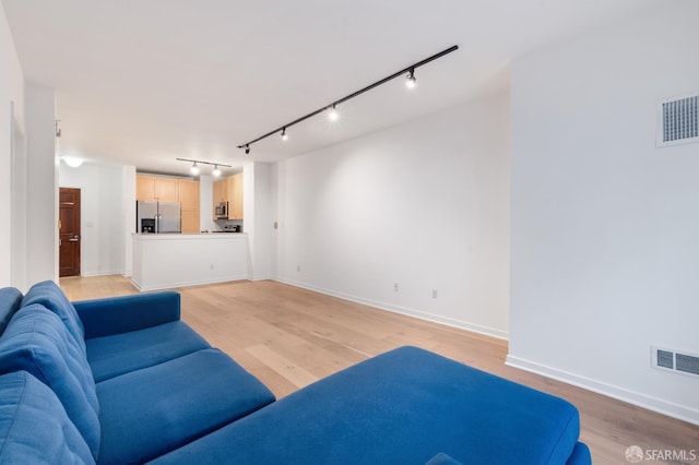 1843 Sutter St Unit 301, San Francisco, CA 94109 - living area with rail lighting, light wood-style floors, and baseboards