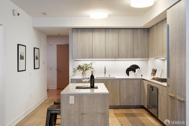 318 Main St Unit 4E, San Francisco, CA 94105 - kitchen with modern cabinets, wall oven, light countertops, light wood-style flooring, and a kitchen island