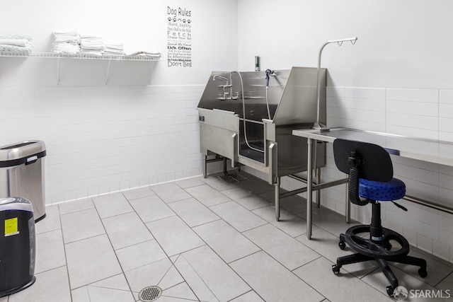 318 Main St Unit 4E, San Francisco, CA 94105 - miscellaneous room with tile walls, pet washing station, light tile patterned floors, and a wainscoted wall