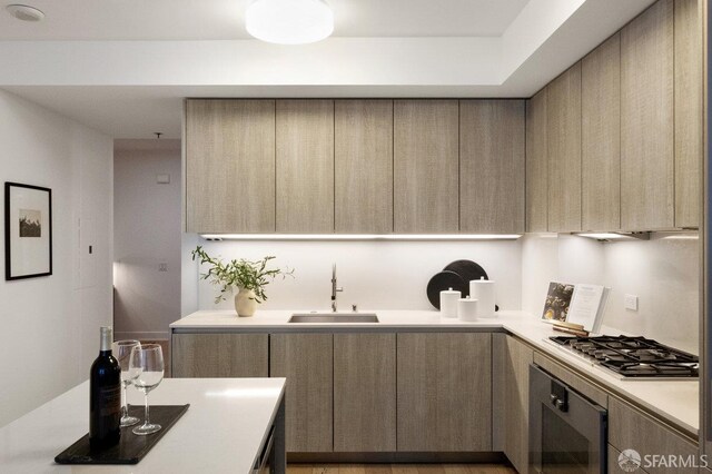 318 Main St Unit 4E, San Francisco, CA 94105 - kitchen featuring oven, stainless steel gas stovetop, modern cabinets, and light countertops