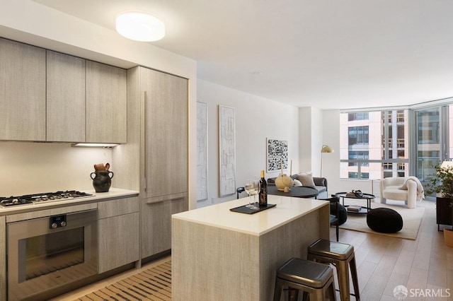 318 Main St Unit 4E, San Francisco, CA 94105 - kitchen featuring oven, a kitchen breakfast bar, modern cabinets, and a center island
