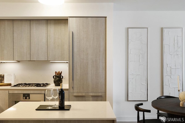 318 Main St Unit 4E, San Francisco, CA 94105 - kitchen with light countertops, wall oven, modern cabinets, a center island, and gas cooktop