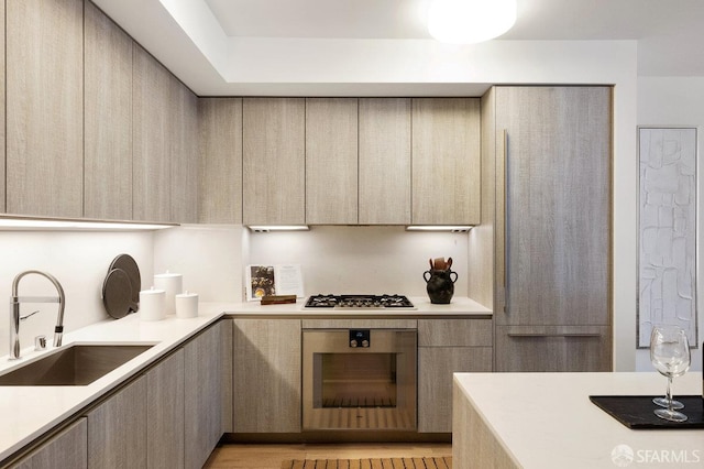 318 Main St Unit 4E, San Francisco, CA 94105 - kitchen featuring appliances with stainless steel finishes, modern cabinets, light countertops, and light brown cabinets