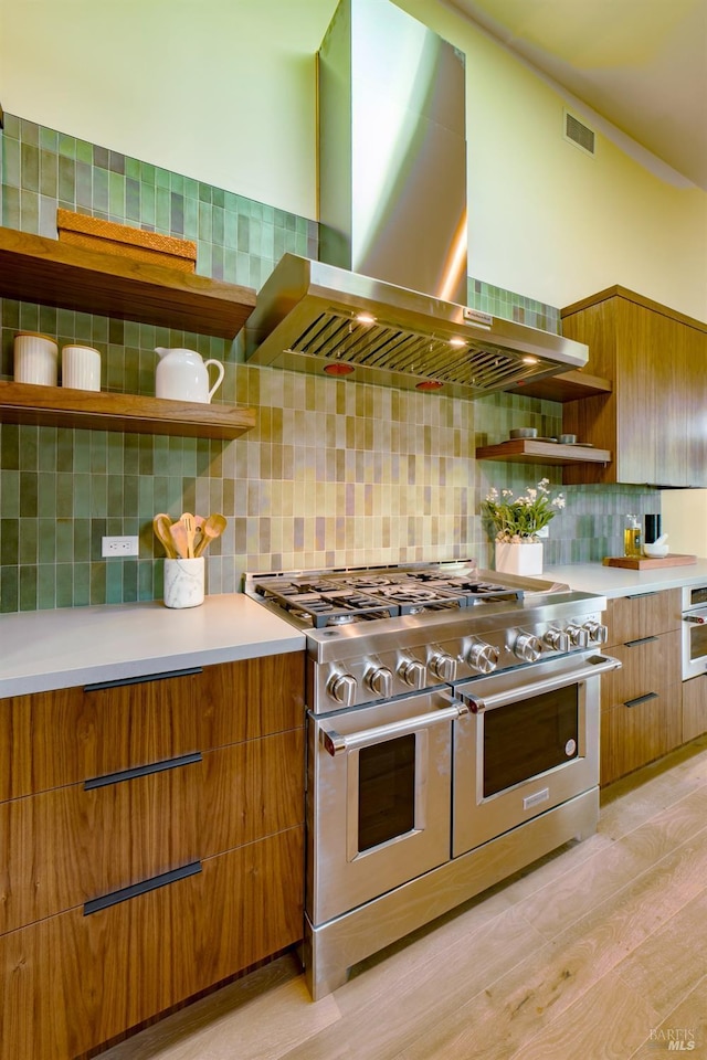 kitchen featuring tasteful backsplash, open shelves, extractor fan, visible vents, and range with two ovens