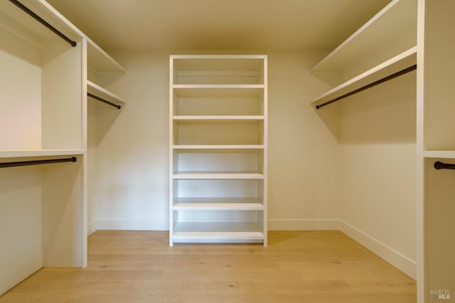 spacious closet with wood finished floors