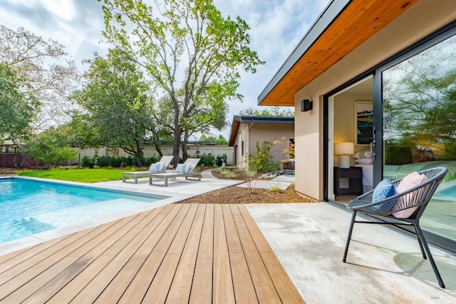 exterior space with a patio, a fenced backyard, a fenced in pool, and a deck