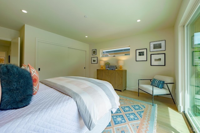bedroom featuring recessed lighting, light wood finished floors, and a closet