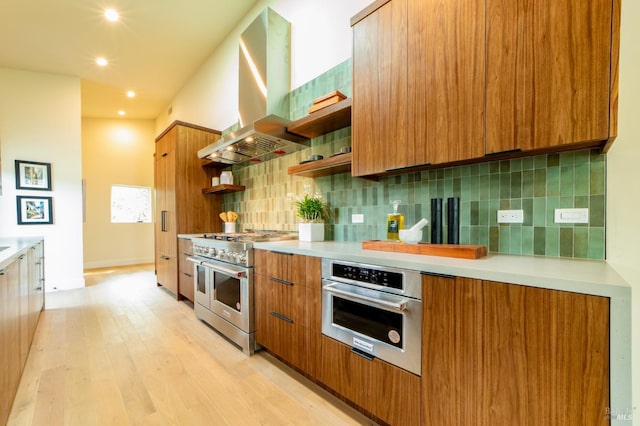 kitchen featuring stainless steel appliances, brown cabinetry, modern cabinets, and island exhaust hood