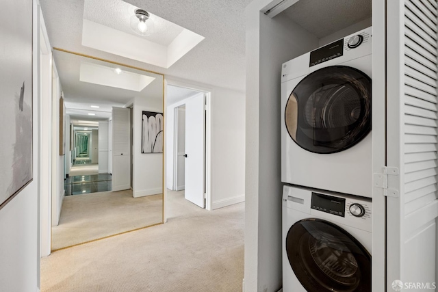 855 La Playa St Unit 360, San Francisco, CA 94121 - laundry area with stacked washer / drying machine, carpet flooring, and a textured ceiling