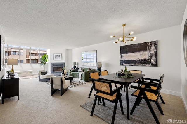 855 La Playa St Unit 360, San Francisco, CA 94121 - carpeted dining space featuring a textured ceiling, a chandelier, and a glass covered fireplace