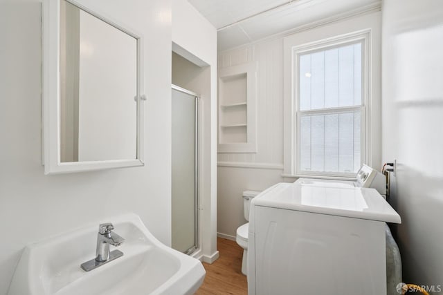 3046-3048 Polk St, San Francisco, CA 94109 - bathroom with washer / dryer, a stall shower, wood finished floors, and built in features