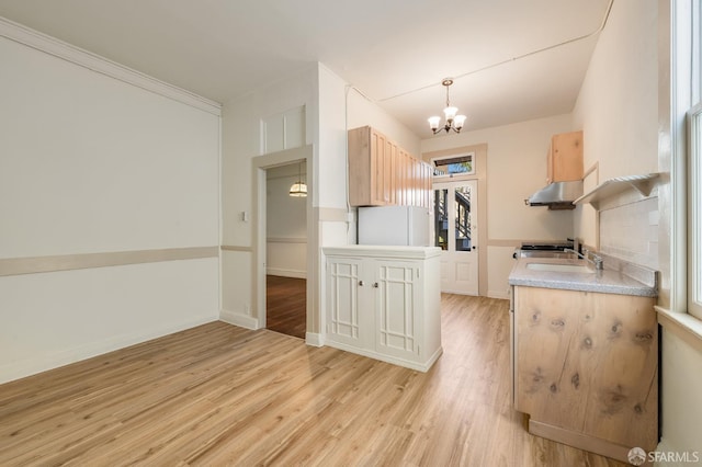 3046-3048 Polk St, San Francisco, CA 94109 - kitchen with a chandelier, light brown cabinetry, light wood-type flooring, light countertops, and freestanding refrigerator